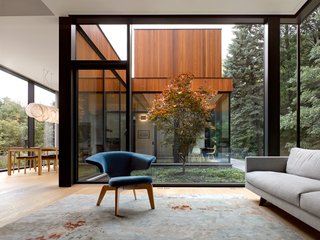 The living room, which is just off the dining room, also overlooks the central courtyard. All of the social spaces are shared by the extended family. 