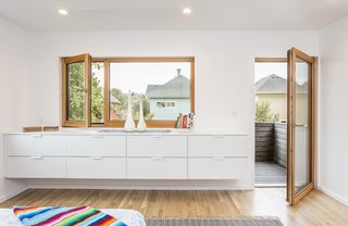The master bedroom is located near the back, and has a private balcony that provides cover for the patio off the living room below. 
