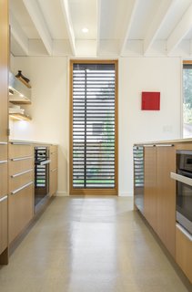 Concrete floors are balanced with natural European Larch windows.