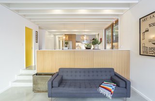 The ceiling throughout the main floor is exposed wood joists and plywood sheathing, all of which were painted white to provide texture and give more character to the room. 