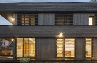The clients' desire of a modern house that fit comfortably into the neighborhood was definitely met. A simple flat roof with a surrounding parapet keeps the height below the other two-story houses in the neighborhood. The simple exterior palette of stained cedar siding and Larch windows were all designed to allow the house to age gracefully over time.