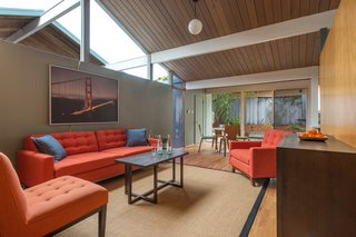 The partition wall enables the family room to take advantage of the natural lighting from the large skylight over the adjacent dining room area. 