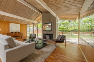 Extensive glazing surrounds the fireplace, keeping the interiors bright and airy. 