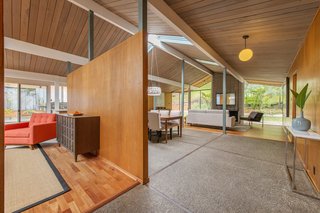 A partition wall separates the spacious family room from the open great room.
