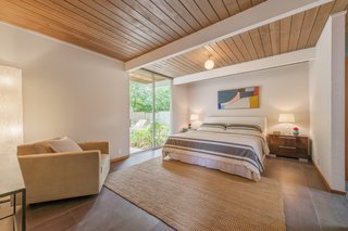 The master bedroom offers tremendous space, as well as a large floor-to-ceiling window. 