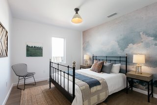One of the three bedrooms features mural-type wallpaper from Anewall.