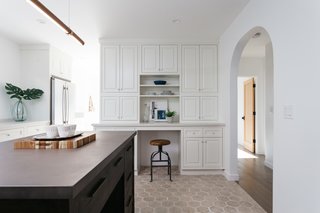 The custom cabinetry includes ample storage and a convenient mini desk.