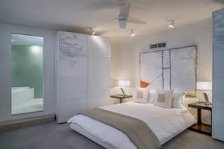 The home has two bedrooms and three baths. Here is the master bedroom from another view, looking into the ensuite bathroom. 
