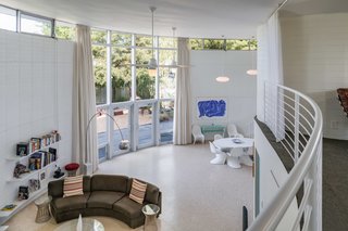 A view from the second floor. Floor-to-ceiling windows keep the interiors bright and airy, while full height curtains provide protection from the heat of the sun. 