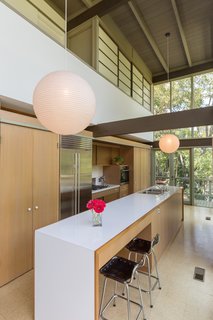 The updated kitchen features a Sub-Zero refrigerator and Miele appliances.