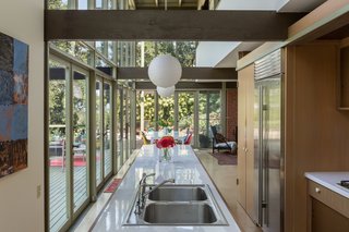 The open layout flows from the kitchen into the dining and living areas.