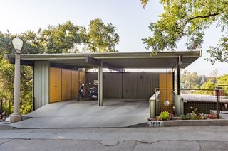 The pop of orange as an accent color is picked up in the carport.