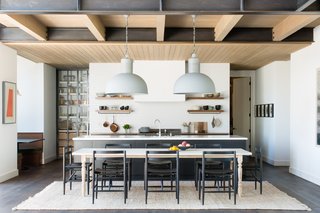 For the kitchen, the homeowner didn’t want a lot of closed cabinetry. So while the island features plenty of concealed storage space, she was excited to have open shelves to display a selection of beautiful pieces from her collection. 
