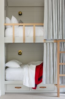 The girls' bedroom was designed for sleepovers and contains four full-size bunk beds and a banquette with a single-size mattress, all custom-designed by ABD Studio. 