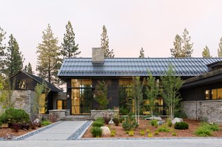 The home is made up of four gabled forms: the main house—with an attached master bedroom suite in its own distinct volume (on the left)—an artist studio, and an attached three-car garage. 