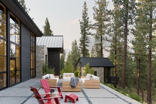 The home backs on Tahoe National Forest, so the surrounding nature that forms the backyard view will remain unchanged. Concrete slabs with a decorative pebble border form the outside terrace, and the separate structure holds the homeowner's art studio. 