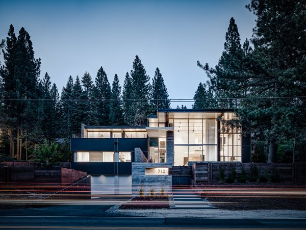 The house is anchored to its sloping site through a series of steps that lead from street-level to front entrance, and through the identification of the garage as a central element of the architecture.