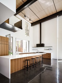 Operable doors and windows capture breezes off the lake that flow through the open garden kitchen window. 
