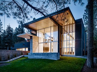 The clients were active participants in the conversation about how to mitigate challenges, such as street traffic noise and how to relieve some of the visual pressure of the openness of the front facade. The garage is located below the envelope of the height- and coverage-restricted house, which results in the floor and driveway being level with the street (a critical detail in snowy climes).