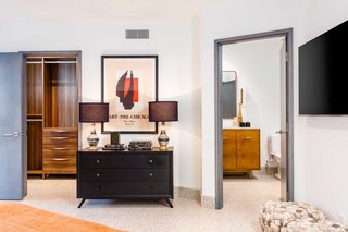 This en-suite bath has custom cabinetry based on midcentury furniture. 