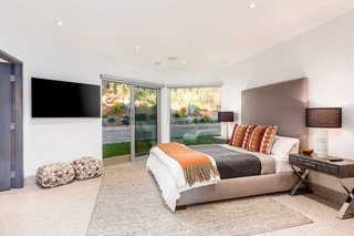 Four bedrooms are interspersed throughout the 6,624-square-foot home.