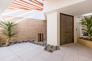 The entrance sets the tone for the home's indoor/outdoor midcentury feel. 