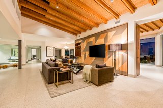 The geometric mural wall is ceramic tile with a solid walnut trim by Spanish company Mutina. 