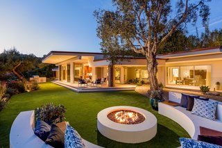 A backyard lounge area complete with a fire pit is perfect for al fresco entertaining. 