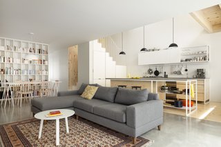 The open-plan living room, dining area, and kitchen are encompassed with bright vibes. 