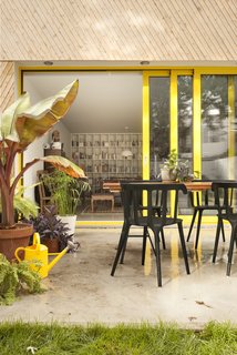 The patio and garden sit just off the interior, which consists of an open-plan living area, dining room, and kitchen. 