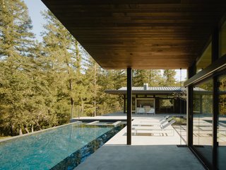 Complemented by 5,600 square feet of outdoor space, the enclosed passage opens up to a central courtyard with a bocce court and a saltwater lap pool.