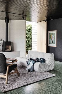 The strategy behind the revamp was to arrange the spaces around three sculptural masonry walls, which would create cozy nooks while also revealing the open plan of the addition.