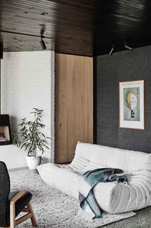 Since the clients requested that the extension be designed to accommodate their diverse collection of artwork and literature, it's no surprise the family's favorite Kandinsky (shown above) served as inspiration for the tonalities and the material palette of the interiors.