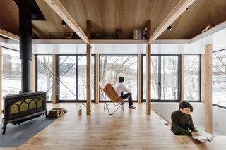 At the other end of the home on the same level, a stove creates a cozy corner, while steps add another layer to the space. 