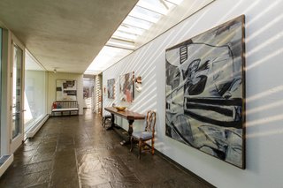 The skylights brighten the long corridor and highlight the homeowner's art collection. 