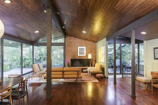 The open-plan great room allows fluidity between functional spaces, while the vaulted wood ceiling contributes to a sense of spaciousness.