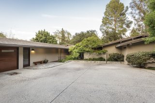 The discreet, private entrance to the residence has a Japanese country home-meets-midcentury modern vibe.