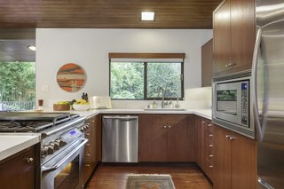 The kitchen also has direct access to the outdoor deck for easy use of the home's deluxe barbecue station. 