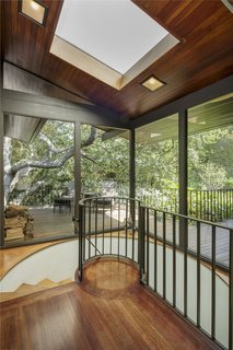 A spiral staircase leads to the lower level. 