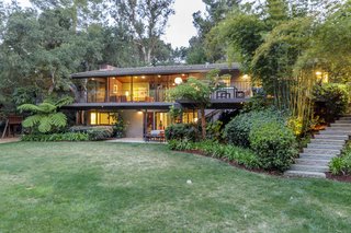 The large lot is beautifully landscaped and dramatically lit at night. 