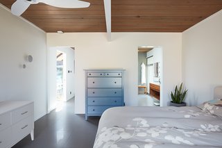 A look at one of the bedrooms with a view into an ensuite bath. 