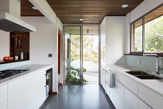 Ample natural light helps to keep the interiors bright. The kitchen countertops have been refinished in Caesarstone Blizzard.