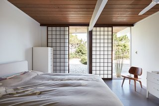 The owners also have kept an added element installed by a previous owner: the sliding shoji panels in all the bedroom windows and sliding glass doors, which serve dual purposes for both privacy and sun control. Grooves have been cut into the new tile flooring for the shoji panels to slide in, creating a more integrated look. 