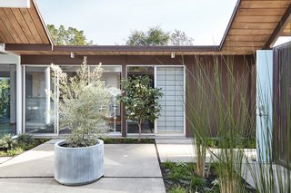 The atrium door at the front entry (on the right) is painted a light blue—the same accent color that has been used in the home's kitchen and bathroom. 