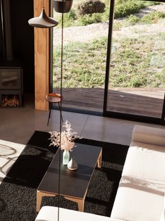 Although the living area is small, the double-height ceilings increases the sense of space.