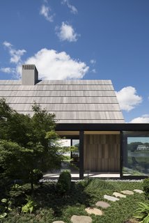 The spaces are arranged around a courtyard to create visual and physical connections. Yet, these connected areas can be broken up by large sliding doors. 