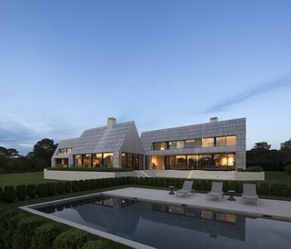 A marble plinth filled with sand elevates the house, while also creating drywells to accept stormwater runoff. 