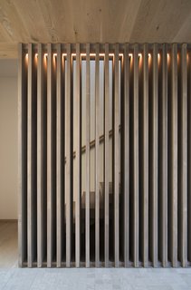A cedar screen adds an openness to the staircase.