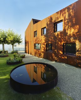 The large terrace is shaded by trees. 