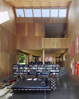 Thirty-foot ceilings feature skylights for increased natural lighting. The walls are paneled in larch and provide concert-hall quality acoustics, and the floors are a polished black concrete. 